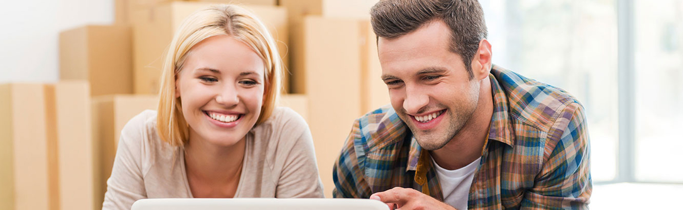 man and woman looking at laptop